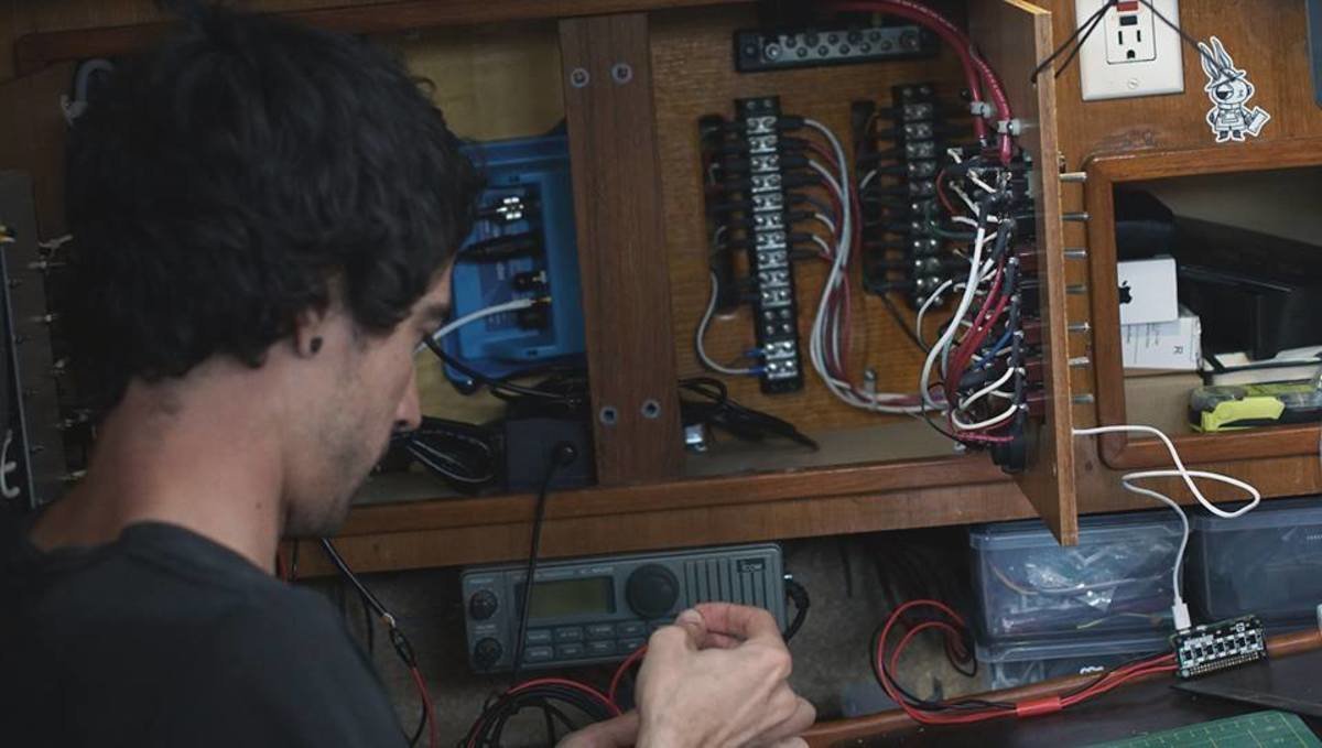 a photo of devine wiring up our new ais system inside the boat