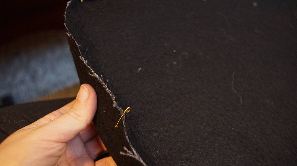 a close-up of top plaque and boxing held together with safety pins