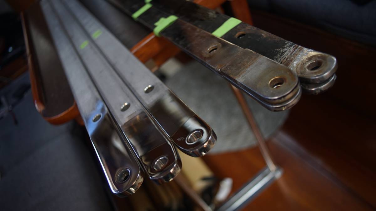 an image showing the newly fabricated and shiny chainplates compared to the old ones