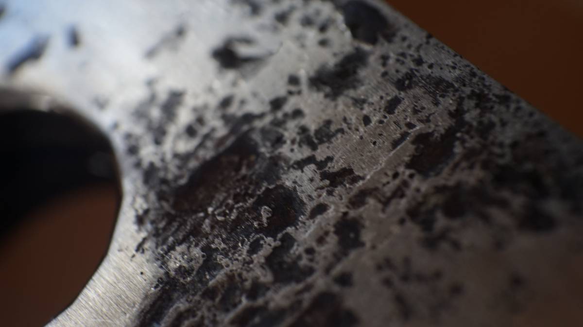 a close up of pitting near one of the bolt holes