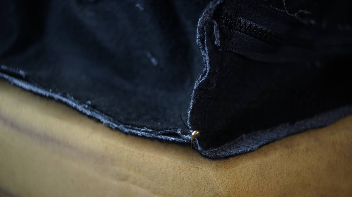 a close up of safety pins holding the cover pieces together