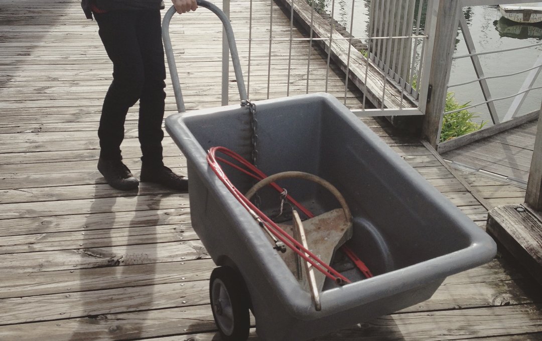a photo of someone pulling a bin holding an anchor