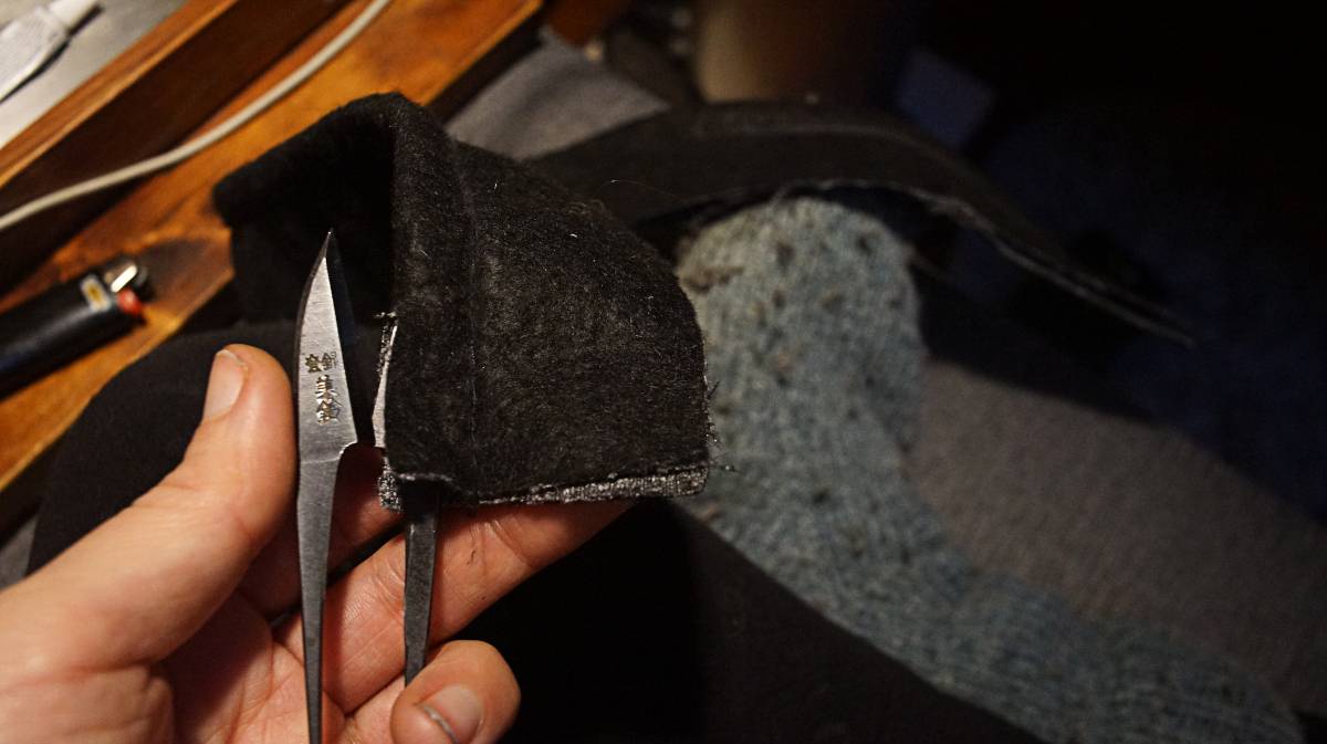 rek is cutting the middle the fold using a pair of scissors to split it in two