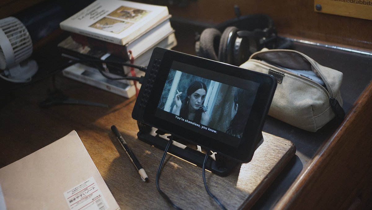 a photo of a desk with a raspberri pi station playing a movie