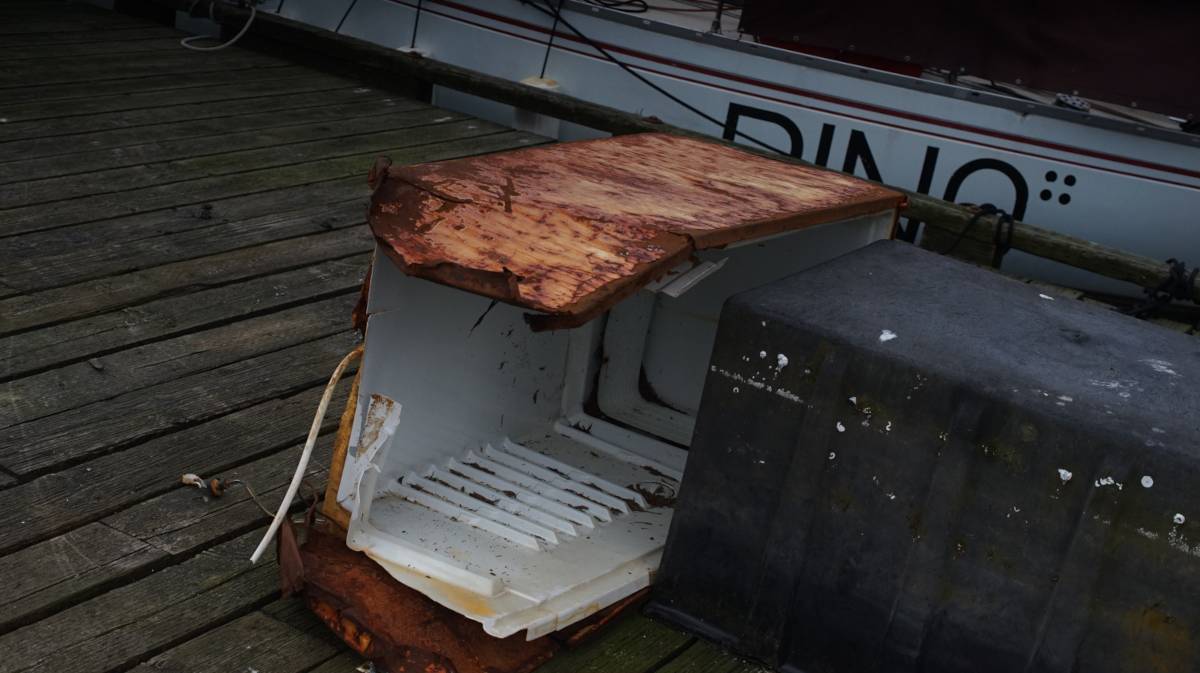 an old rusty refrigerator on the port neville goverment dock