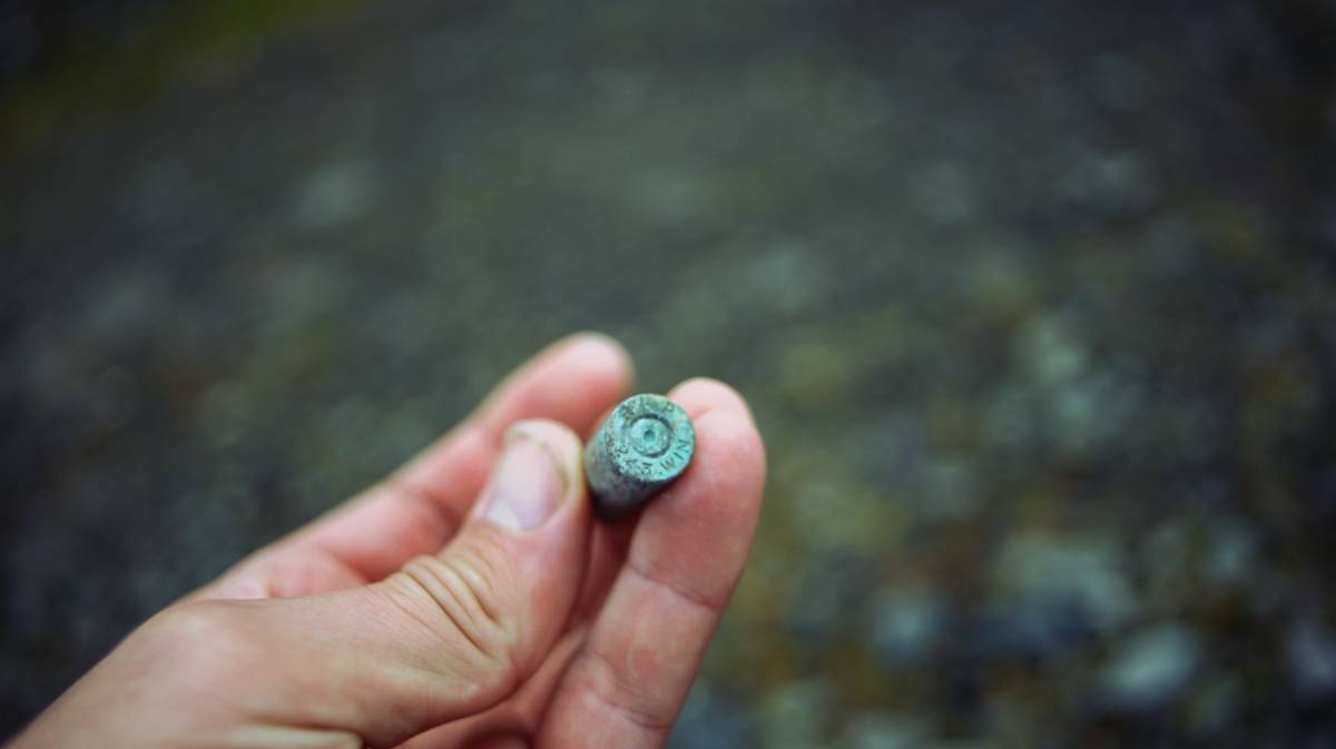 devine holding an old winchester .243 bullet casing