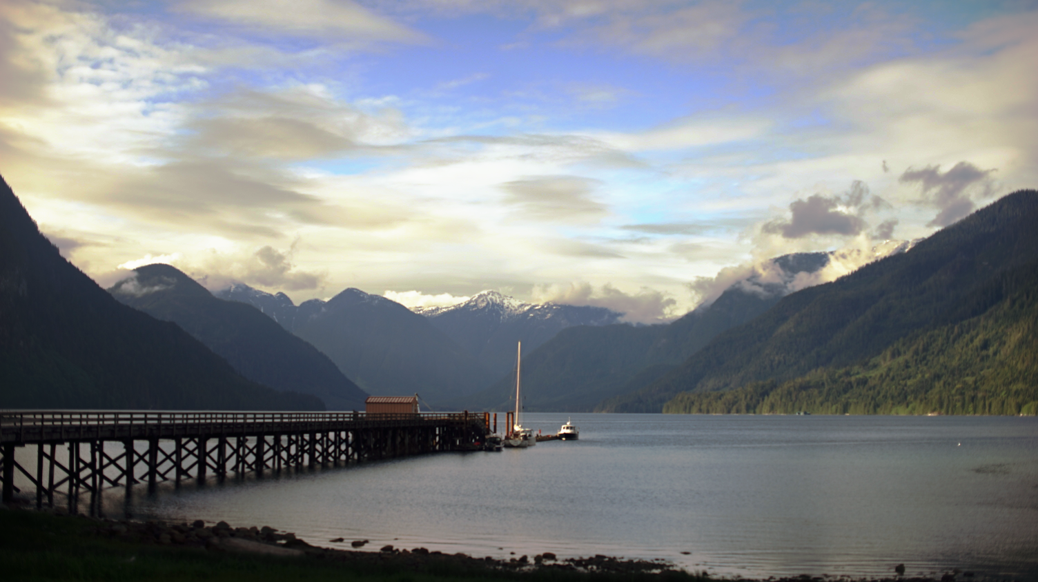 view of shoal bay from the land, showing the government dock on a beautiful spring evening