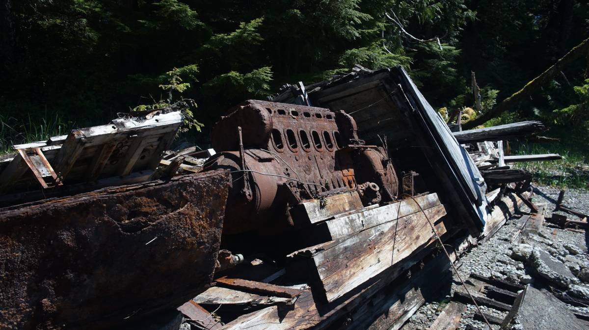 a rusty wreck on a small islet, the rusty engine is visible