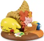 A figure of a Pikachu sleeping inside a cornucopia next to half-eaten food, including an Oran Berry.