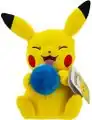 A plush toy of a Pikachu holding an Oran Berry.