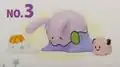 A figure of a sad Goomy with a spilled Casteliacone in front of it and a Poké Doll next to it.