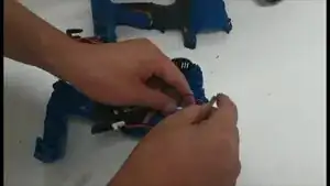 Place the LEDs and their cables back into the case, then do the same for the motor and its cables.