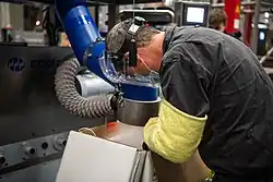A Pfizer employee putting dry ice in a box to protect the COVID-19 vaccines during transport at the Puurs factory
