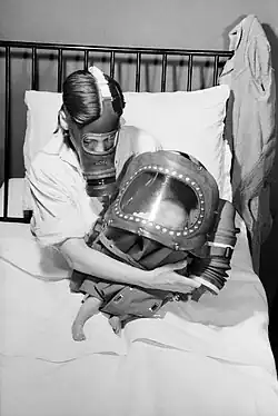 A mother and baby, both in gas masks, during WWII.