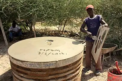 A mason building latrines to slabs which can be used for toilets to achieve improved sanitation in Dadaab, Kenya
