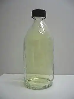 A glass container filled with yellow chlorine gas