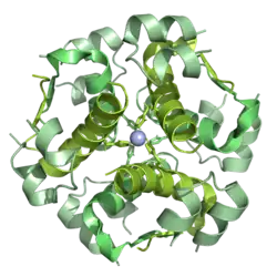 3D model of a protein structure with green and yellow helices spiraling around a central sphere
