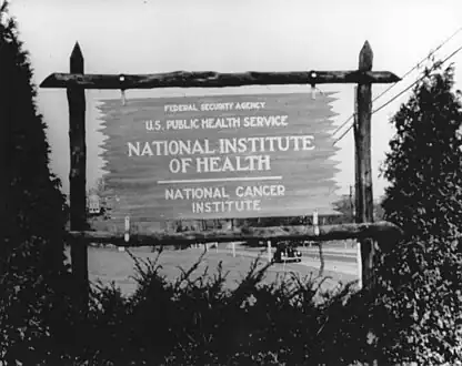 An early wooden sign for the National Cancer Institute