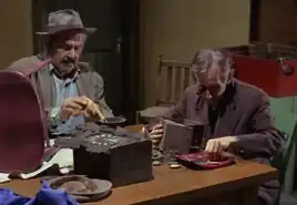 ...as a Clock repairman (left)