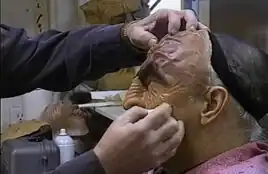 Quashnick's hands applying makeup to Martok actor J.G. Hertzler for <i>Star Trek: Deep Space Nine</i>