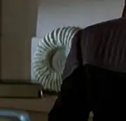 A fossil ammonite in Jean-Luc Picard's ready room aboard the USS Enterprise-E in 2373.