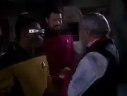 Geordi La Forge and William Riker greet Montgomery Scott