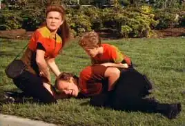 Latika helping a wounded Tom Paris