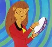 M'Ress playing a tambourine