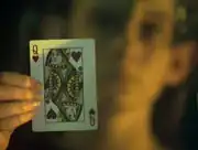 Mezoti holds up the queen of hearts