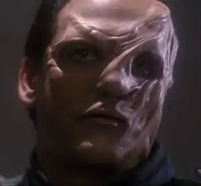 Orgoth, an Ossarian male disfigured by a spatial anomaly