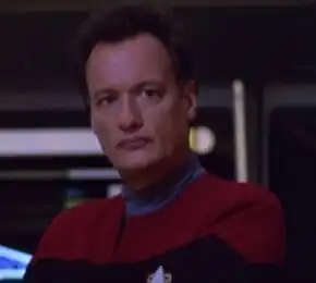 Q, a Q in the form of a Human male