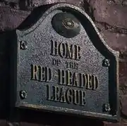 Redheaded league sign