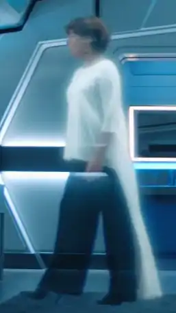 Siobhan speaks with Tilly via hologram.