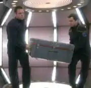 Tanner and crewman move cargo container