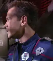 Tucker wearing a radiation meter