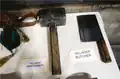 A behind the scenes photo of a weaponsmith's hammer and a butcher's cleaver.