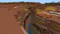 A river in a badlands plateau in Bedrock Edition