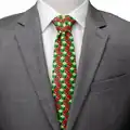 A mannequin wearing the "Creeper TNT Isometric Green Men's Tie".