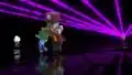 Two enchanters in the Minecraft Live: Announcement Trailer 2020. The one in the front is hitting a chicken jockey with its book, while the one in the back is casting an Enchanted Beam.