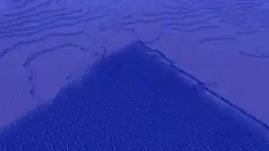 The corner of the world boundary in 1.2.5. Normal terrain is at the bottom of the image; fake chunks are at the top. Note there is neither sand nor clay on the seafloor.