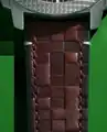 "Embrossed brown leather strap"