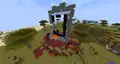 A giant ruined portal generated in a savannah next to a desert.