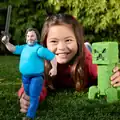 A child playing with Steve and a creeper.