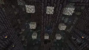 A magma cube spawner in a bastion remnant, being disabled with solid blocks.