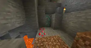 Naturally generated diamond and redstone ores in a cave.