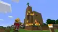 Creeper holding a fishing rod on a burning building while King watches.