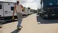Jason skateboarding past trailers out of character.