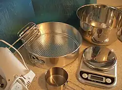 Cooking implements: beaters, large bowl, cup measurement and large cake tin. Scales optional.