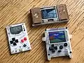 The Gamebuino next to a Pokitto and an Arduboy.