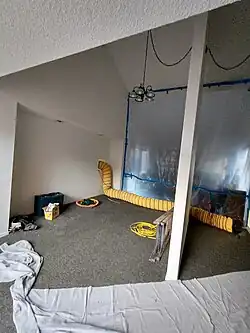 Sectioning off of several clean spaces (that were supposed to be kept habitable) behind dust curtain walls; removal of flooring